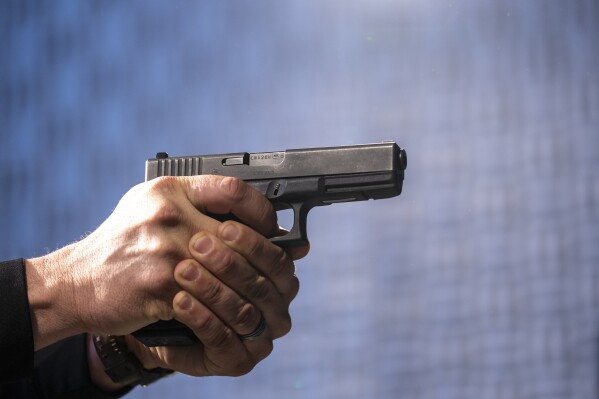 A semi-automatic Glock pistol is fired at the Bureau of Alcohol, Tobacco, Firearms, and Explosives (ATF), National Services Center, March 2, 2023, in Martinsburg, W.Va. (AP Photo/Alex Brandon, File)